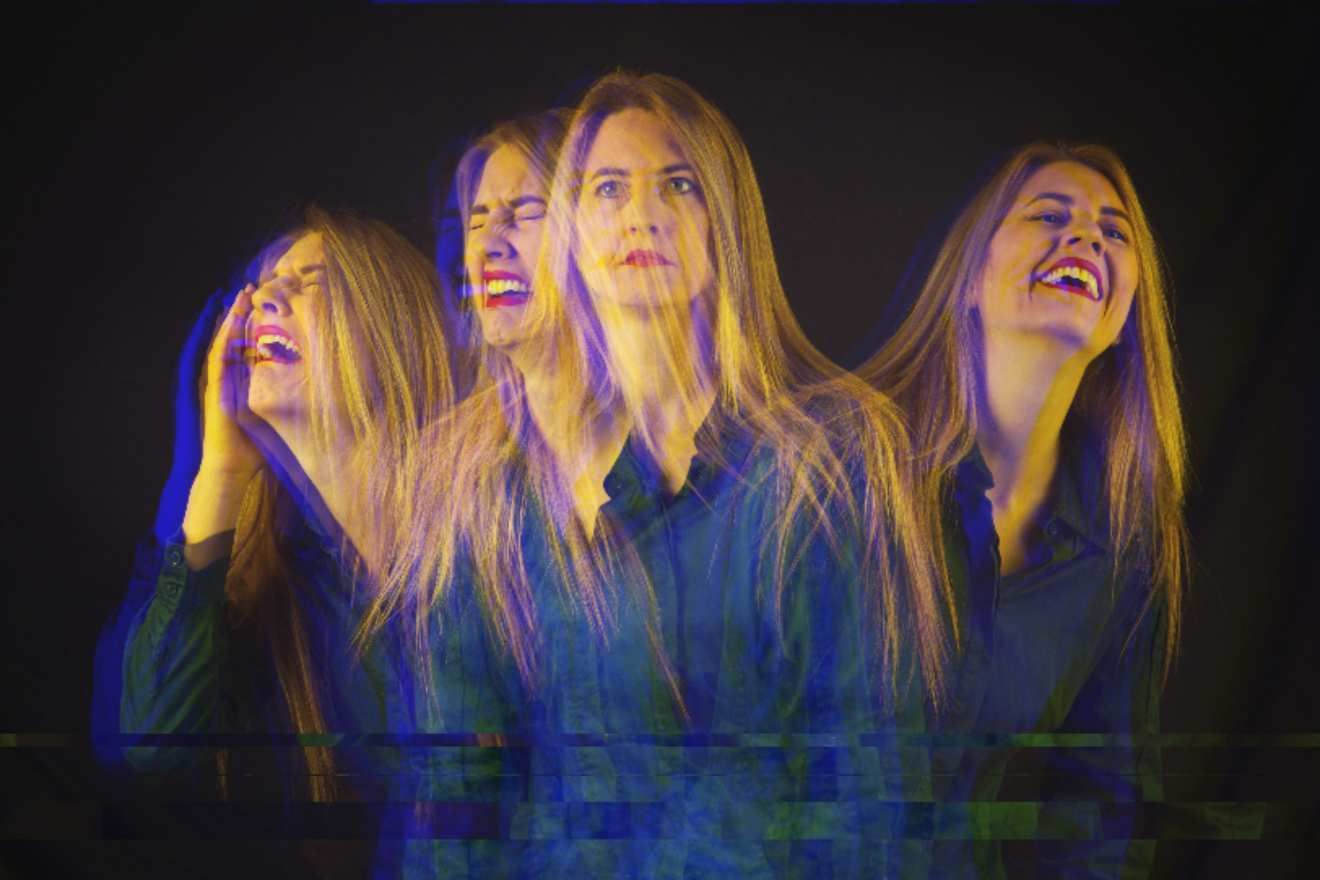 Emotional Healing with Ayahuasca. Image is a person with different versions of themselves extending from the one in the center, in varying degrees of fragmented focus. The version on the left is clearly in agony, and the version on the right is laughing, and the two in the middle make it a gradual transition from the one extreme to the other.