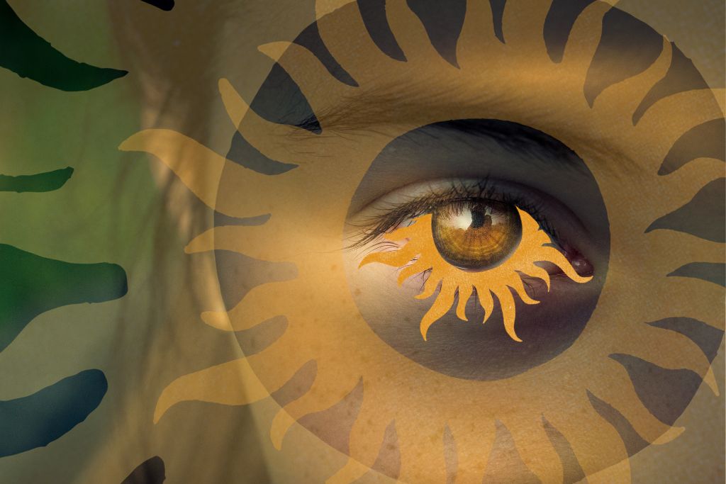 Psychedelic Intention. Image is a close up of a person's right eye which is golden brown and their eyebrow. Surrounding the  iris of the eye is a graphic of a sun in a soft orange. 
Two graphics of the same sun circle the initial one, each increasingly larger, and more opaque.