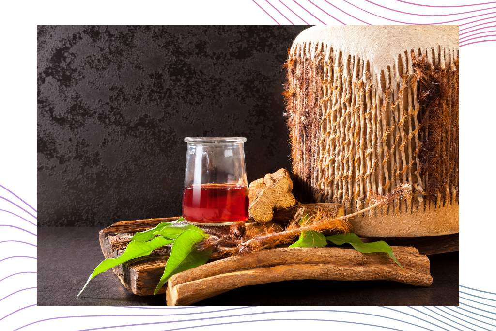 DMT Substance Guide. Image is of an Ayahuasca bew, placed on some bark from the tree, next to a stool.