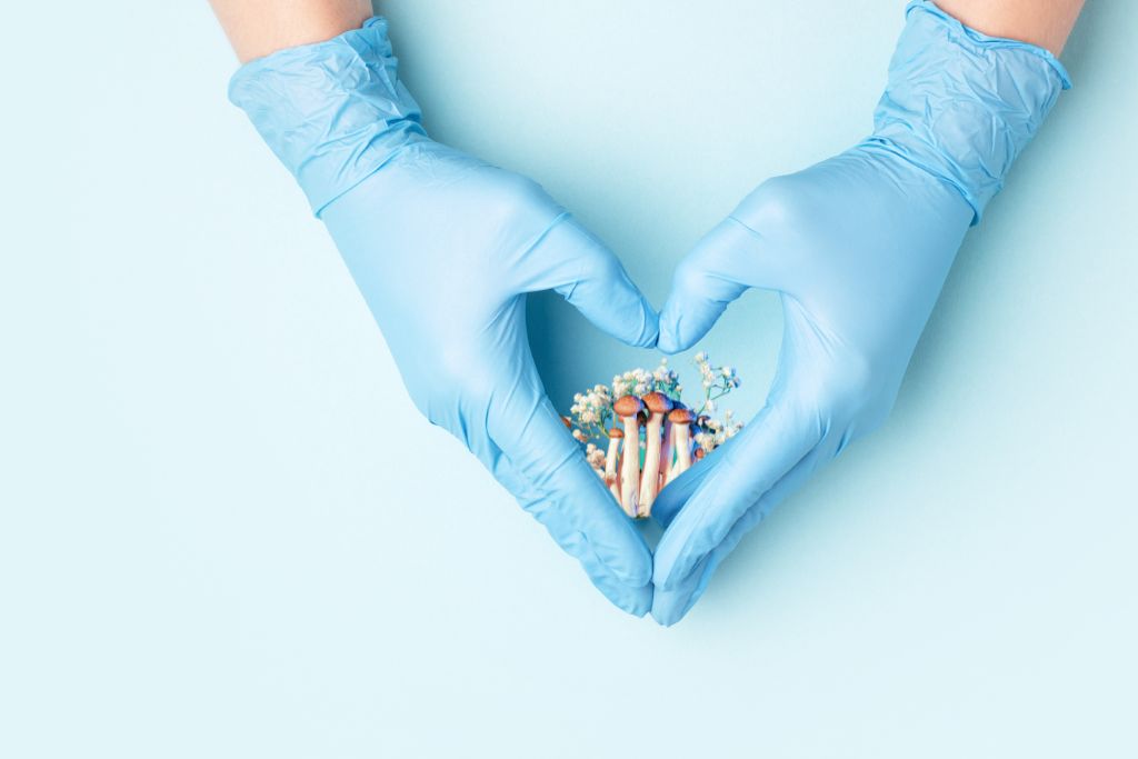 Nurse's hand holding psychedelic mushrooms