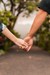 Two people holding hands, visible from the elbow down. Couples therapy can lead to a stronger relationship.