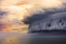 Pessimism bias. A massive incoming storm on the right and a tiny sailboat on the left.