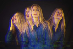 Emotional Healing with Ayahuasca. Image is a person with different versions of themselves extending from the one in the center, in varying degrees of fragmented focus. The version on the left is clearly in agony, and the version on the right is laughing, and the two in the middle make it a gradual transition from the one extreme to the other.