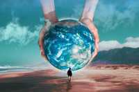 Creative process. A surreal beach scene where a person walks toward a massive Earth held between two giant hands, featuring cool turquoise and sandy tones with soft clouds and mountains in the background.