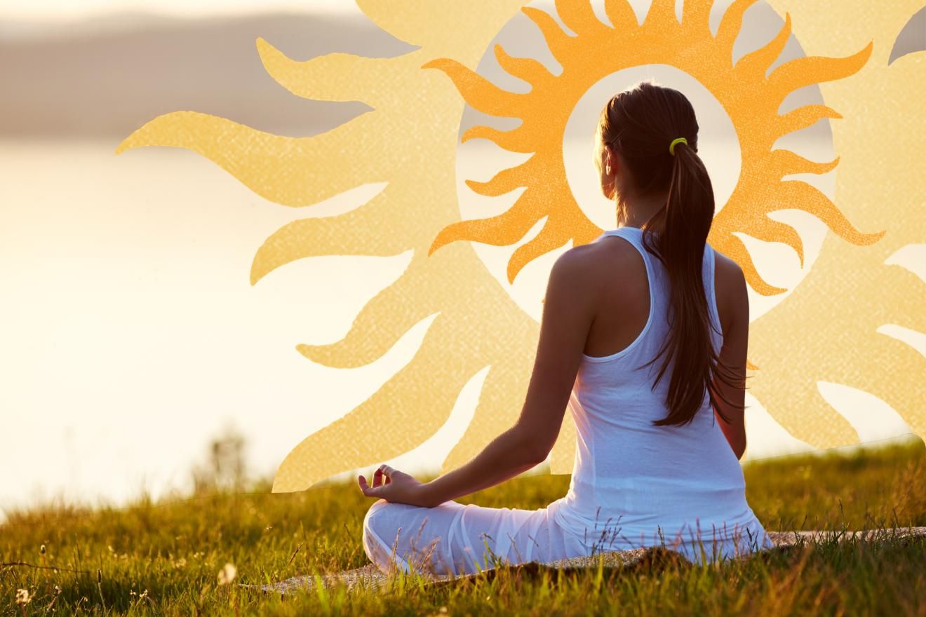Psychedelic Intention. Image is of a female-presenting person sitting on the grass facing away from the camera, overlooking a river out of focus. They are wearing white clothes, and their hair is tied up in a ponytail, and appears to be brown, They are surrounded by soft sunset colours, and there is a graphic of a sun in front of them, framing their head. The sun is two layers of the same sun pattern in in flat-colours - the outer, larger one in soft yellow, and the smaller, inner one in soft orange.