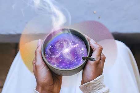 Inflammation and mental health. A person holds a steaming cup filled with a swirling galaxy of purples, blues, and pinks, blending cosmic imagery with a warm, earthy, and meditative composition.