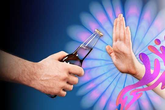 Psychedelic Treatment for Alcohol Use Disorder. A photograoh of a hand coming from the left side of the image, handing a bottle of alcohol to someone on the right. From the right side of the image, a different person's hand is declining the alcohol with a "no" or "stop" motion. Behind the hand is a blue and purple floral radiating light pattern, and swirling around the person's hand are some pink and purple psychedelic liquid shapes.