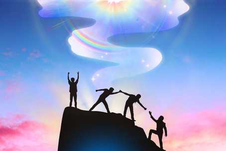 Stigma around psychedelics. The image shows the silhouette of four figures atop a rocky peak, symbolizing teamwork and achievement. One figure stands triumphantly with raised arms, while the others assist each other in climbing. The background is a vibrant gradient of blue, pink, and purple hues, creating a dreamy sky. A swirling, ethereal light with a rainbow sheen and sparkling stars rises into the sky, leading to a radiant, glowing sun at the top. The composition conveys inspiration and unity, with a celestial and uplifting atmosphere.