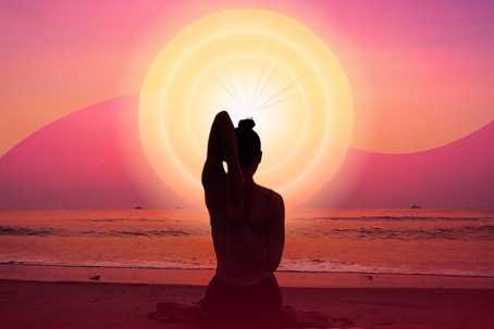 After the Ceremony. The image showcases a serene beach scene during what appears to be sunrise or sunset. At the center is the silhouette of a person sitting in a meditative yoga pose, with one arm stretched behind their back, creating a peaceful and balanced composition. The background features a gradient sky transitioning from soft pinks to warm oranges, blending seamlessly with the bright sun radiating concentric circular patterns of light. The calm ocean reflects the warm hues, while the figure is perfectly framed against the glowing sun, emphasizing a sense of harmony and spirituality.