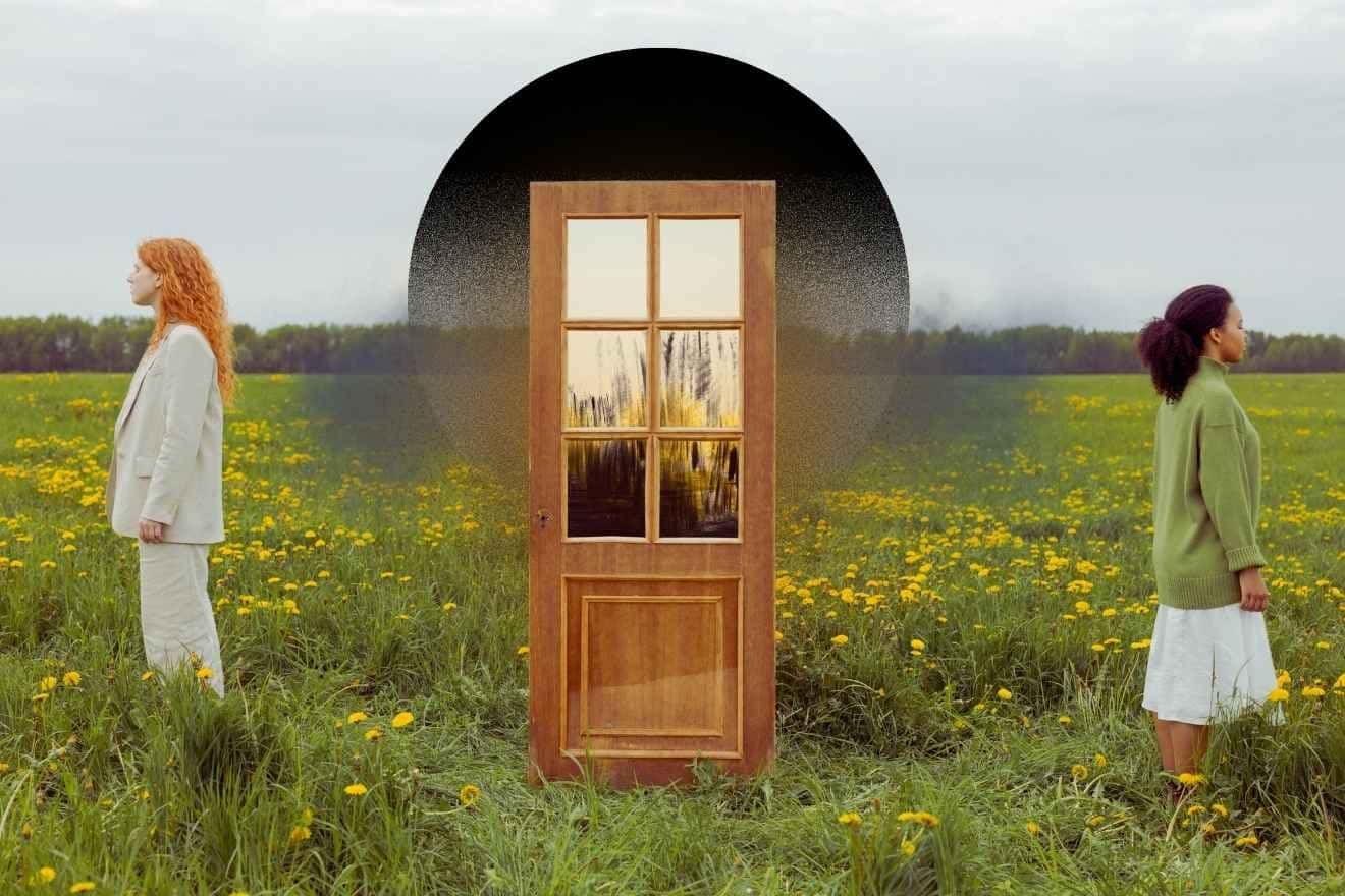 Structural dissociation. Two people stand facing away from each other in a green field of yellow flowers, separated by a central wooden door framed by a dark arch, creating a symmetrical, surreal composition in soft natural greens, yellows, browns, and muted neutrals.