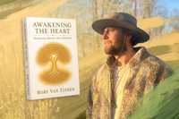 Ibogaine therapy. A book titled Awakening the Heart: Reclaiming Identity After Addiction by Rory Van Tuinen appears beside a portrait of the author wearing a wide-brimmed hat and fleece jacket, looking into the distance against a softly blurred natural background with warm golden tones and painterly brushstroke accents.