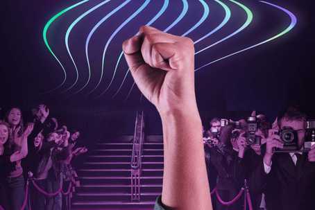 These influential people started foundations to support psychedelics. Image is of a triumphant, raised fist, with a purple-tinted background showing a group of cheering fans on the left, and a group of paparazzi on the right, with a clear path to a set of stairs ahead. There are neon-looking wavy lines in the air following the direction of the pathway.